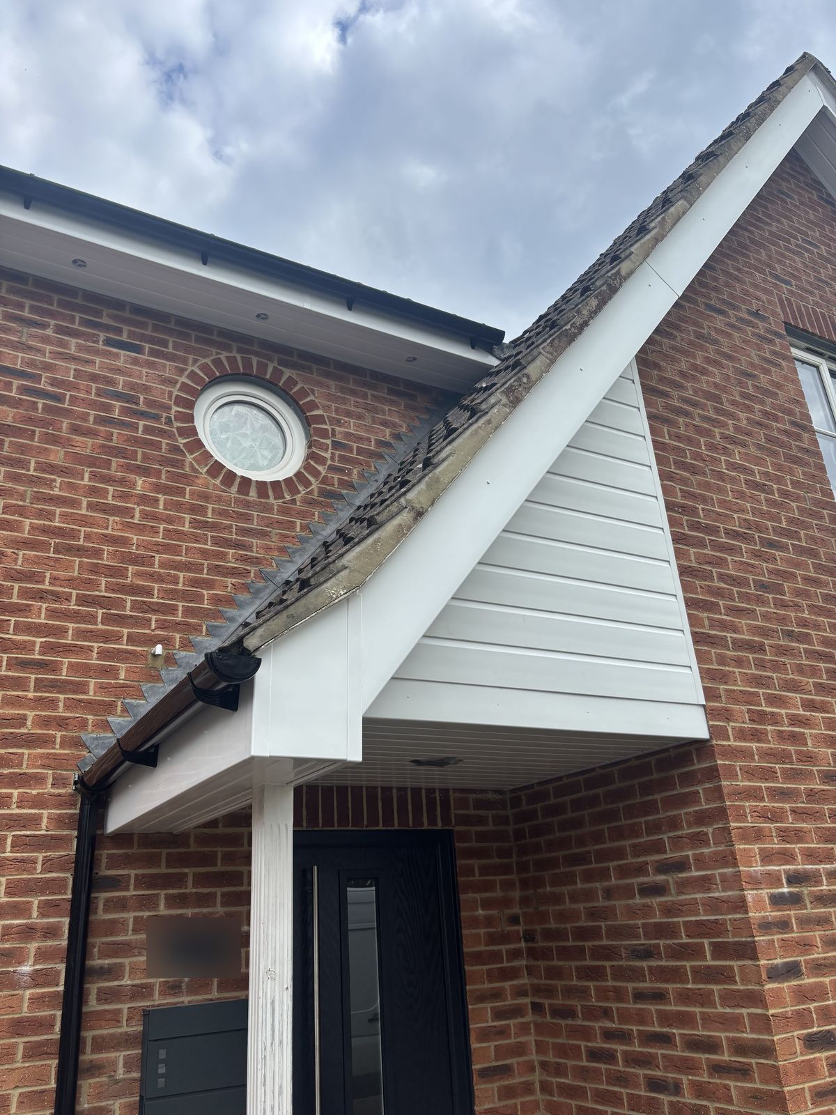 Same porch after: new white uPVC fascia, soffit and cladding